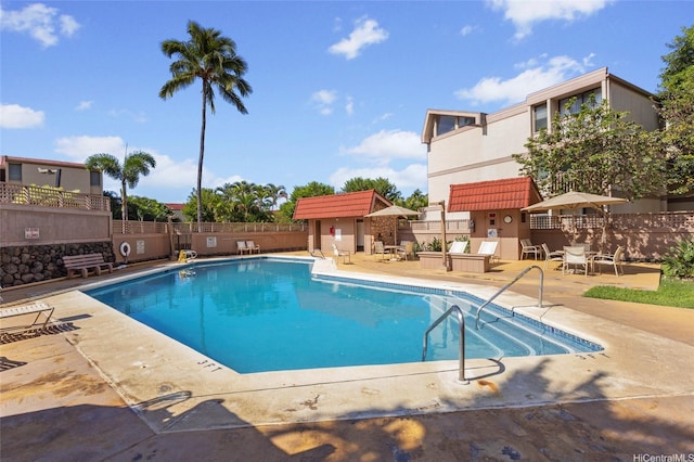 pool featuring a patio and fence