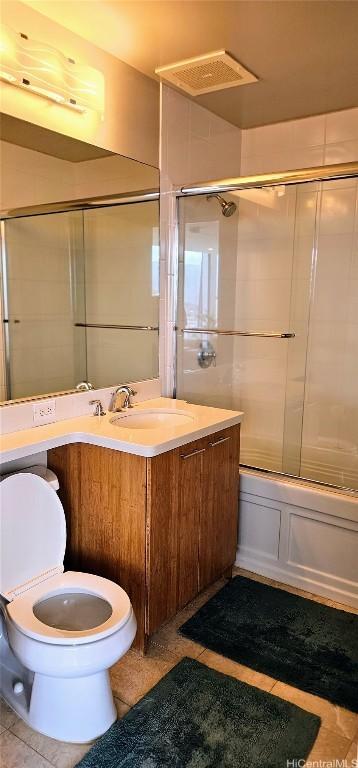 full bathroom featuring visible vents, toilet, enclosed tub / shower combo, vanity, and tile patterned flooring
