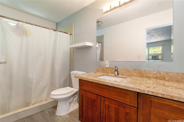 47-325 Ahuimanu Rd, Kaneohe, HI 96744 - full bath with curtained shower, wood finished floors, toilet, and vanity
