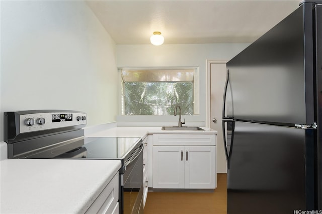 47-325 Ahuimanu Rd, Kaneohe, HI 96744 - kitchen with a sink, stainless steel appliances, white cabinetry, light countertops, and wood finished floors
