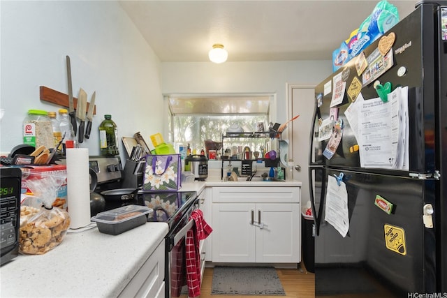 47-325 Ahuimanu Rd, Kaneohe, HI 96744 - interior space with freestanding refrigerator, electric range, light countertops, light wood finished floors, and white cabinetry