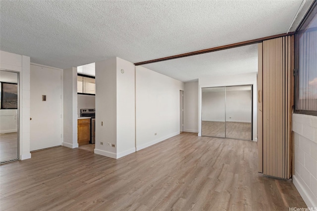 99-015 Kalaloa St Unit 803, Aiea, HI 96701 - unfurnished bedroom featuring light wood-style floors, a textured ceiling, and baseboards