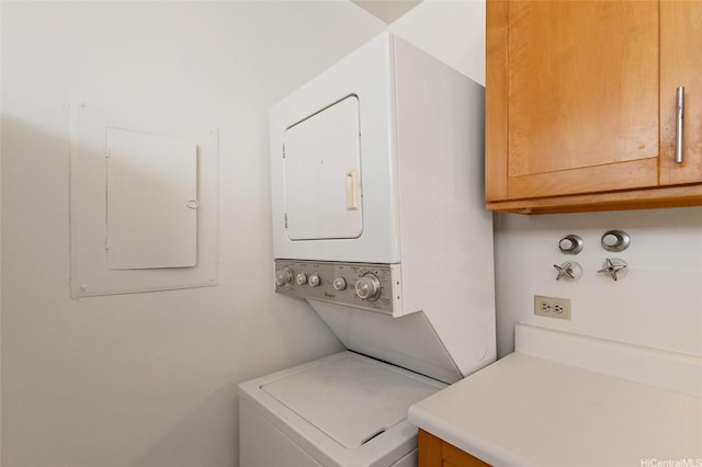 99-015 Kalaloa St Unit 803, Aiea, HI 96701 - washroom featuring stacked washer / dryer, electric panel, and cabinet space