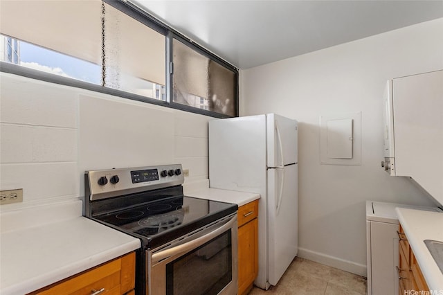 99-015 Kalaloa St Unit 803, Aiea, HI 96701 - kitchen with stainless steel electric range oven, light countertops, and brown cabinetry