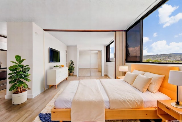 99-015 Kalaloa St Unit 803, Aiea, HI 96701 - bedroom with light wood-style flooring and baseboards