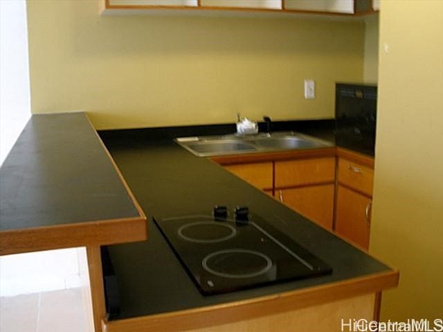 53-549 Kamehameha Hwy Unit 514, Hauula, HI 96717 - kitchen featuring black electric cooktop, dark countertops, and a sink