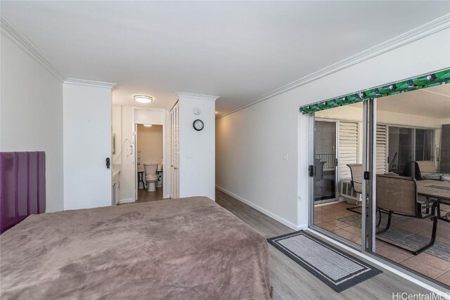 469 Ena Rd Unit 505, Honolulu, HI 96815 - bedroom featuring ornamental molding, baseboards, a closet, and wood finished floors