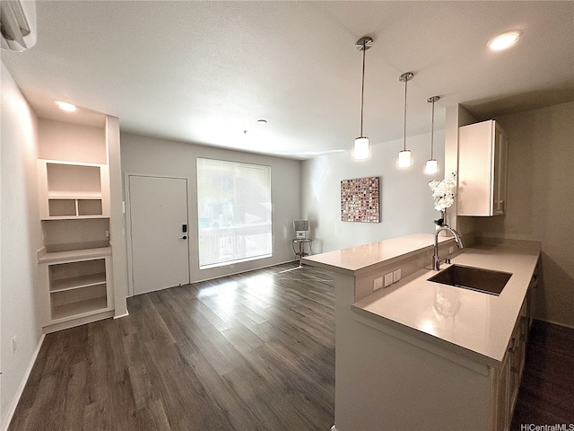 91-3525 Kauluakoko St Unit 2213, Ewa Beach, HI 96706 - kitchen with dark wood finished floors, light countertops, hanging light fixtures, recessed lighting, and a peninsula