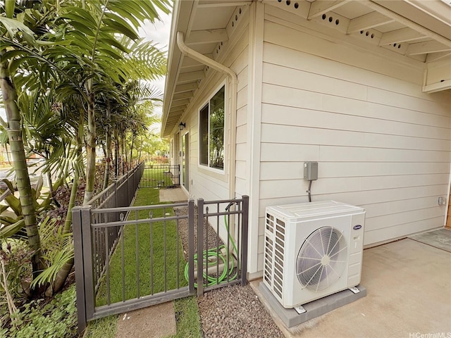 91-3525 Kauluakoko St Unit 2213, Ewa Beach, HI 96706 - view of home's exterior featuring a cooling unit, fence, and a gate