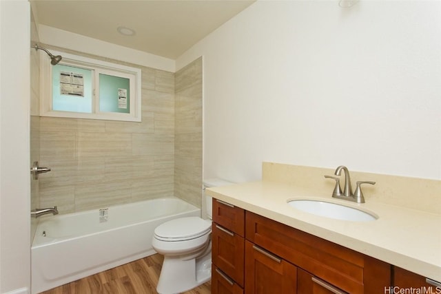 full bathroom featuring wood finished floors, toilet, vanity, and bathing tub / shower combination