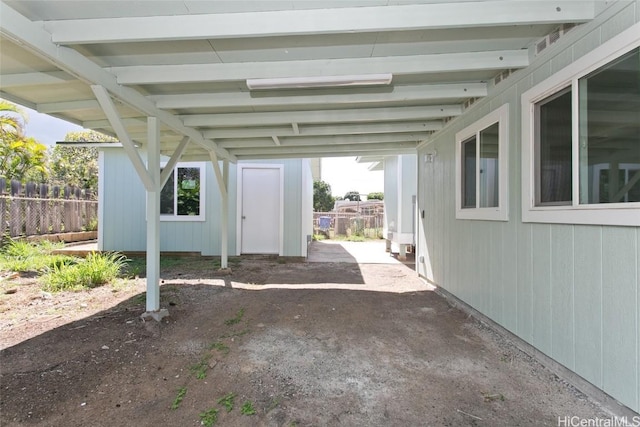 view of patio featuring a carport and fence