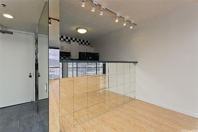 60 N Beretania St Unit 3405, Honolulu, HI 96817 - kitchen featuring rail lighting, a textured ceiling, and freestanding refrigerator