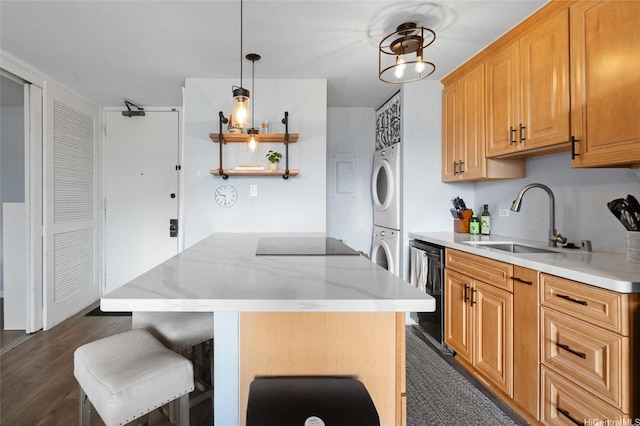 kitchen featuring a sink, dishwashing machine, stacked washer / drying machine, black electric stovetop, and a kitchen island