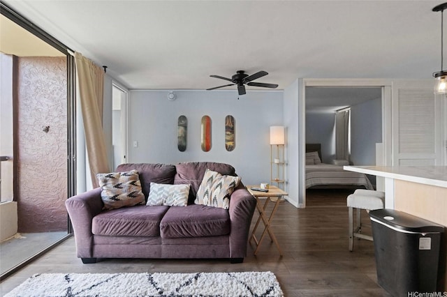 living room with wood finished floors and ceiling fan