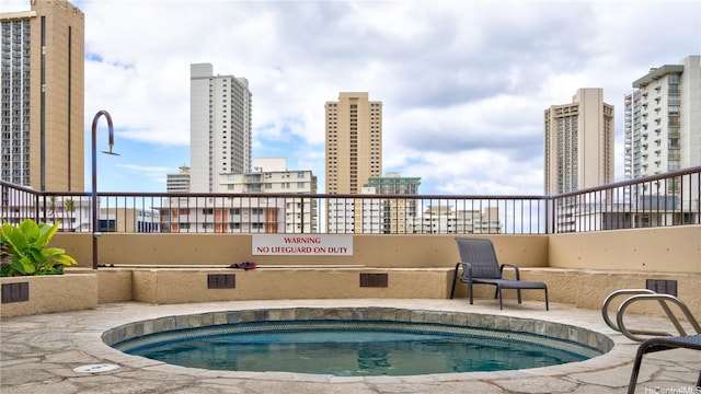view of swimming pool with a city view