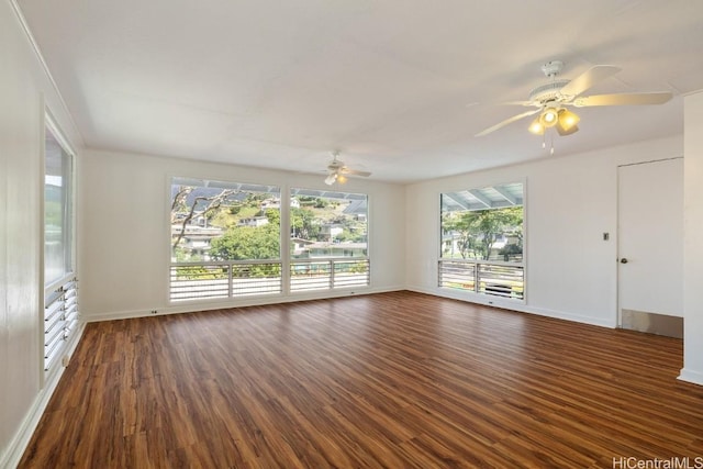 unfurnished living room with baseboards, dark wood-style floors, and ceiling fan