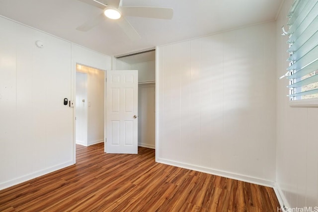spare room featuring a ceiling fan, baseboards, and wood finished floors