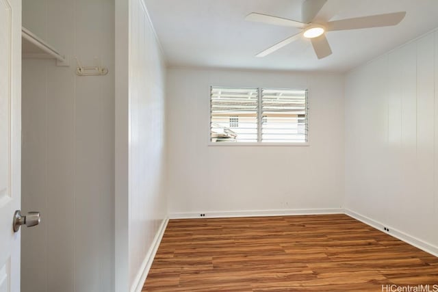 unfurnished room featuring baseboards, ceiling fan, and wood finished floors