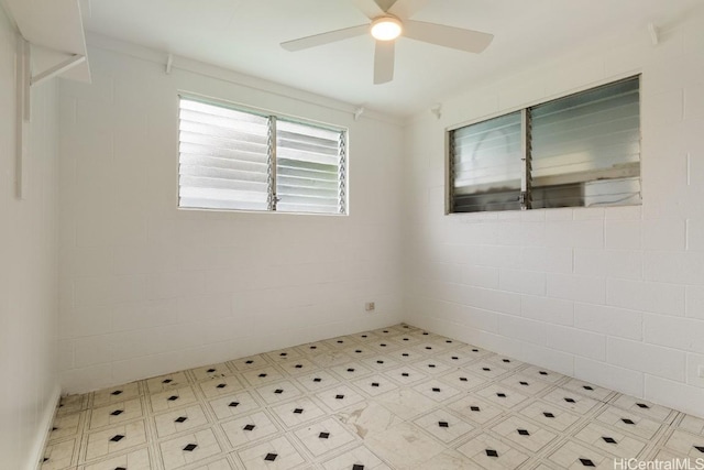 spare room featuring tile patterned floors and ceiling fan