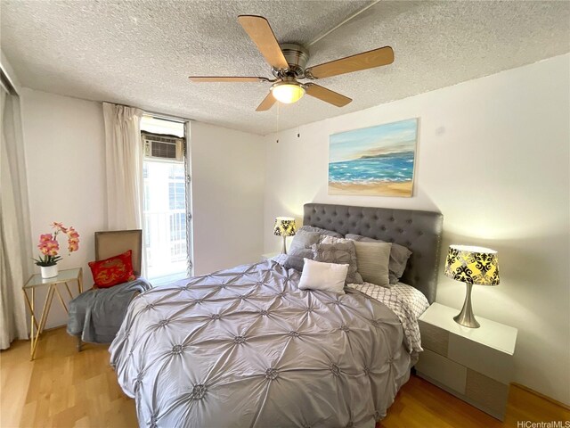 2452 Tusitala St Unit 703, Honolulu, HI 96815 - bedroom with wood finished floors, a textured ceiling, and ceiling fan