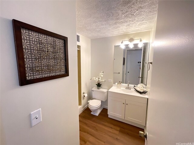 2452 Tusitala St Unit 703, Honolulu, HI 96815 - bathroom with vanity, wood finished floors, and a textured ceiling