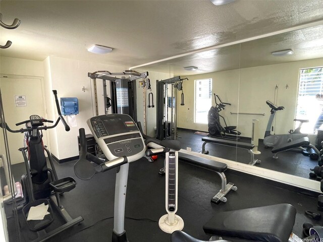 2452 Tusitala St Unit 703, Honolulu, HI 96815 - exercise room with baseboards and a textured ceiling