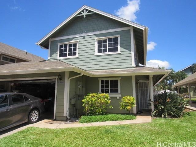 traditional-style house featuring an attached garage and a front lawn