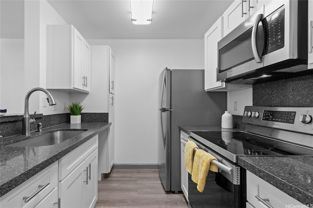 95-510 Wikao St Unit F206, Mililani, HI 96789 - kitchen with stainless steel appliances, a sink, white cabinetry, and light wood-style floors