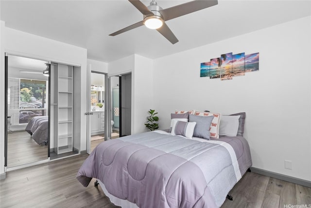 95-510 Wikao St Unit F206, Mililani, HI 96789 - bedroom featuring wood finished floors, baseboards, ceiling fan, and ensuite bathroom