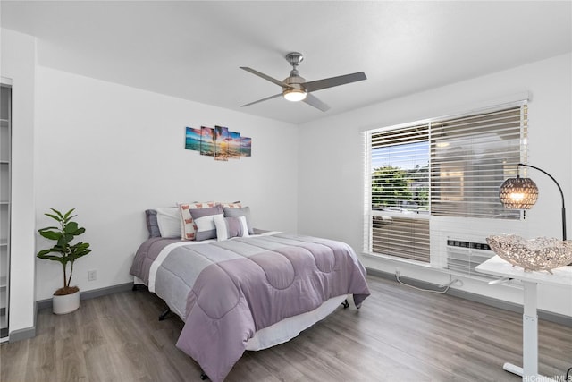 95-510 Wikao St Unit F206, Mililani, HI 96789 - bedroom with wood finished floors, baseboards, and ceiling fan