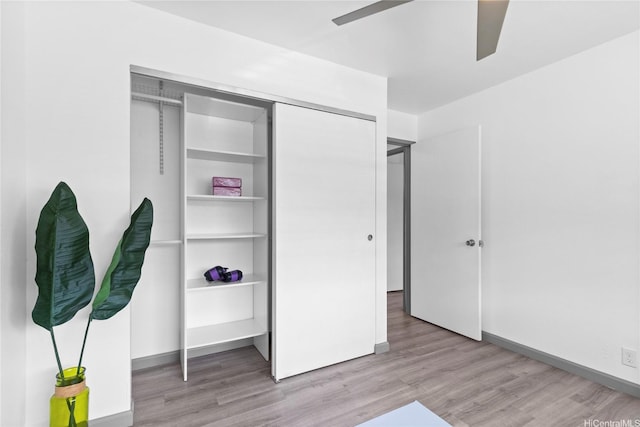 95-510 Wikao St Unit F206, Mililani, HI 96789 - unfurnished bedroom with light wood-type flooring, baseboards, a ceiling fan, and a closet