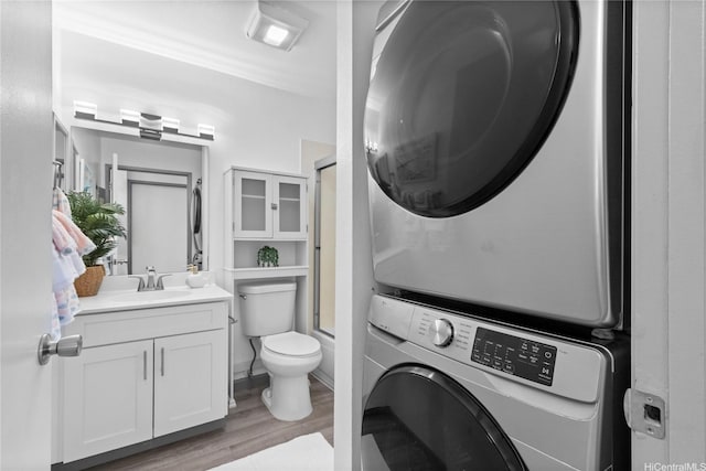 95-510 Wikao St Unit F206, Mililani, HI 96789 - clothes washing area featuring estacked washer and dryer and light wood-style flooring