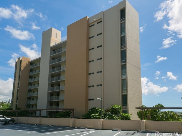 view of building exterior with uncovered parking