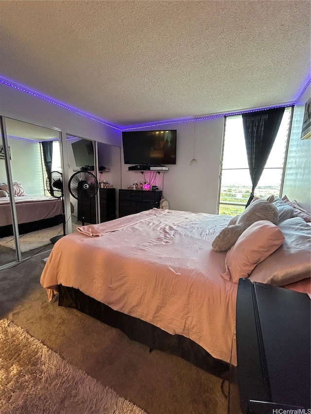 bedroom with a textured ceiling and carpet floors