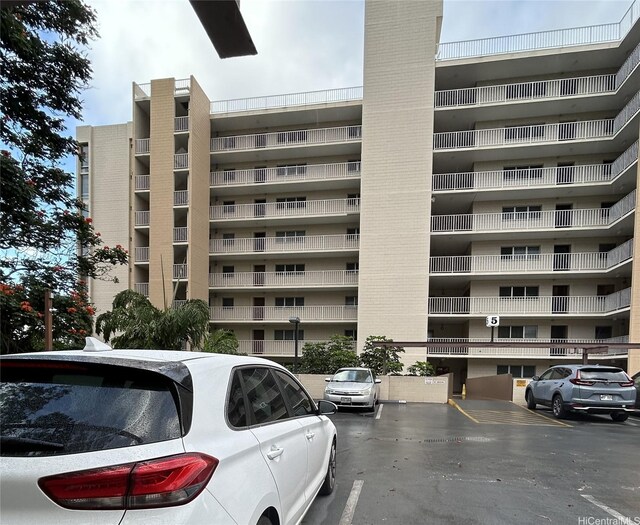 view of building exterior with uncovered parking
