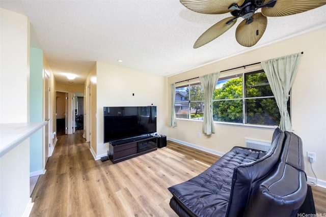 living area featuring baseboards and wood finished floors