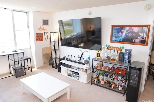 carpeted living area featuring visible vents