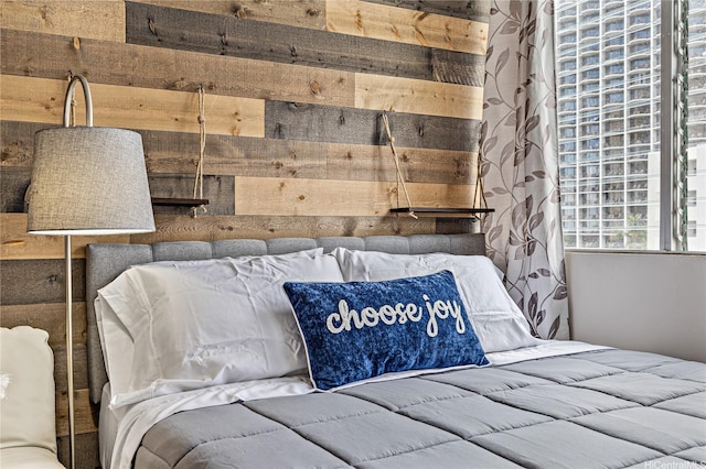 bedroom with wood walls