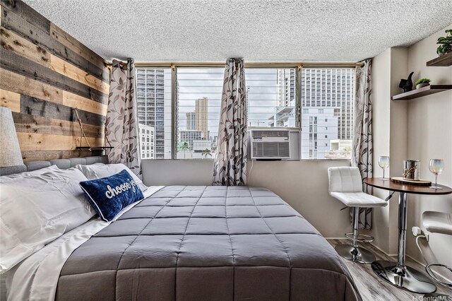 bedroom with a textured ceiling and cooling unit