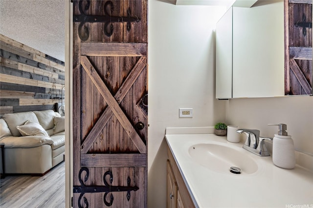 bathroom featuring vanity, wood finished floors, and wooden walls