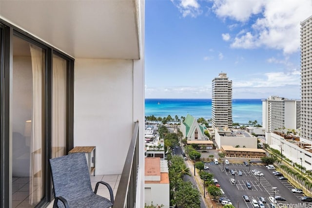 balcony with a water view and a city view