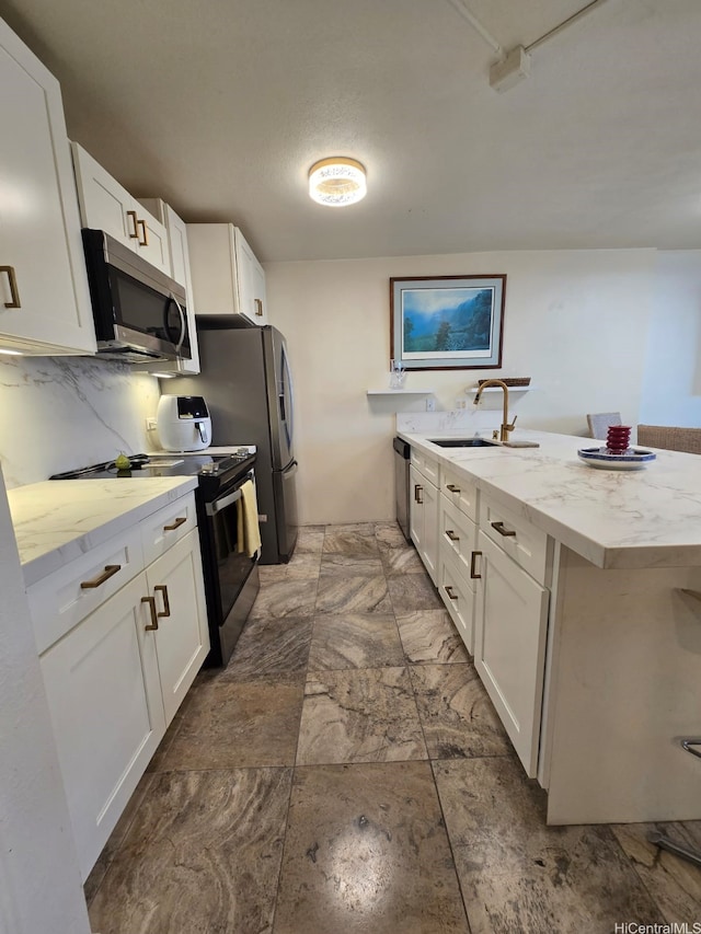 60 N Beretania St Unit 3209, Honolulu, HI 96817 - kitchen featuring appliances with stainless steel finishes, white cabinetry, light stone countertops, a peninsula, and decorative backsplash