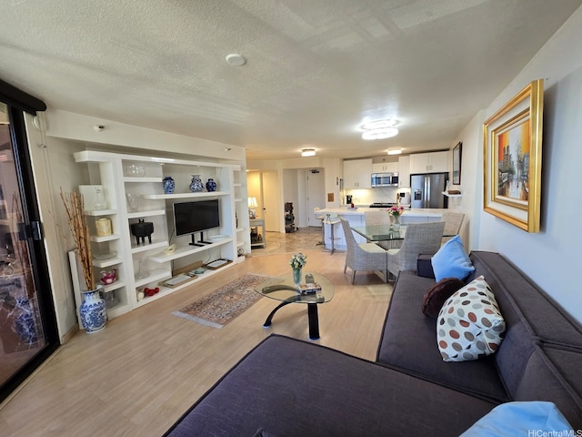 60 N Beretania St Unit 3209, Honolulu, HI 96817 - living room with light wood finished floors, a textured ceiling, and built in features