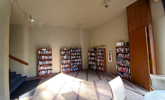 60 N Beretania St Unit 3209, Honolulu, HI 96817 - sitting room with wall of books, carpet, and stairway