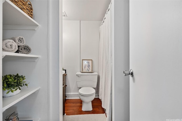 bathroom with wood finished floors, vanity, a shower with shower curtain, and toilet