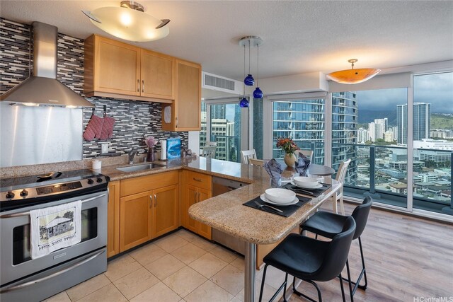 1288 Kapiolani Blvd Unit I2903, Honolulu, HI 96814 - kitchen featuring backsplash, visible vents, wall chimney exhaust hood, stainless steel range with electric cooktop, and a sink