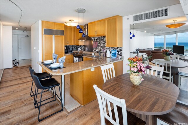 1288 Kapiolani Blvd Unit I2903, Honolulu, HI 96814 - kitchen with stainless steel electric range, light brown cabinets, rail lighting, and visible vents