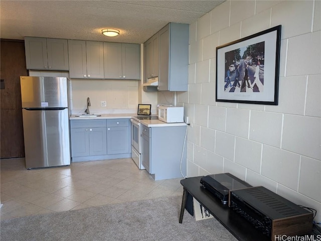2845 Waialae Ave Unit 116, Honolulu, HI 96826 - kitchen featuring white appliances, under cabinet range hood, gray cabinetry, a textured ceiling, and a sink
