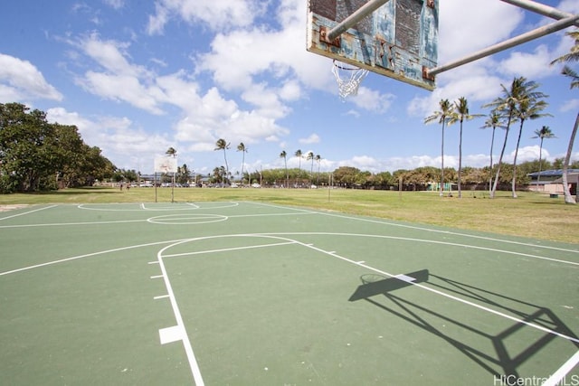 view of basketball court with a lawn and community basketball court