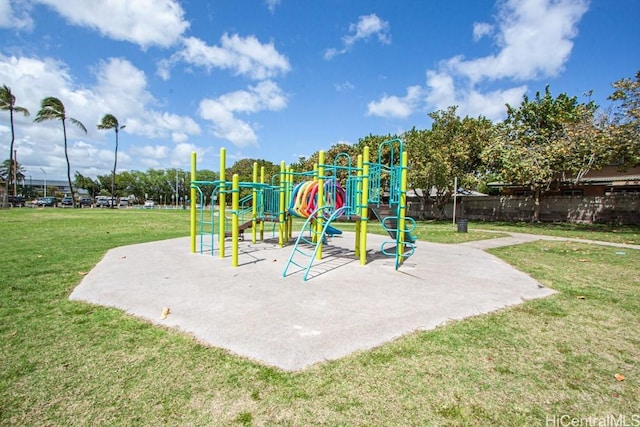 community jungle gym featuring a yard